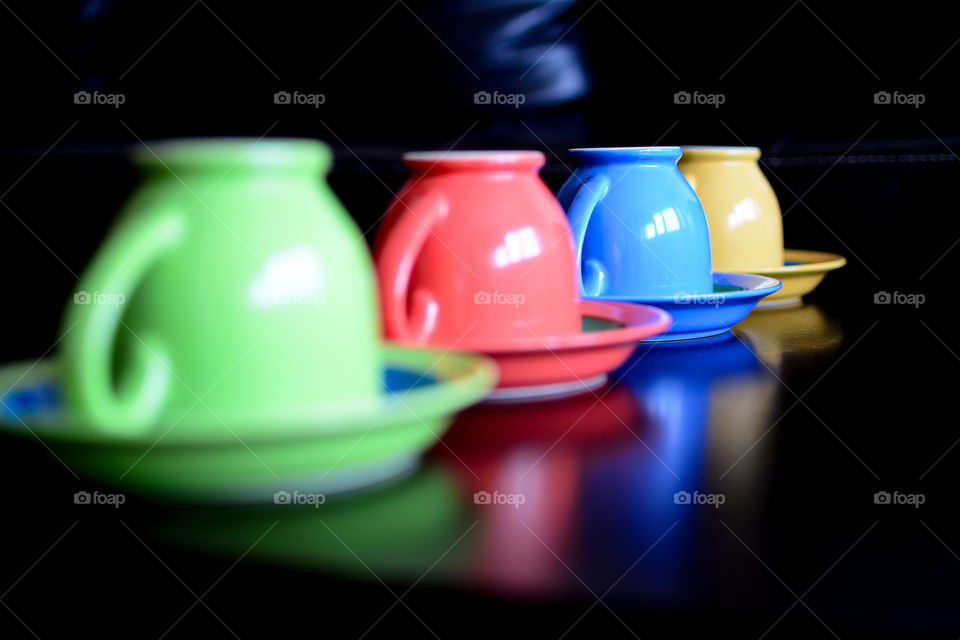 Multi colored cups in row on table
