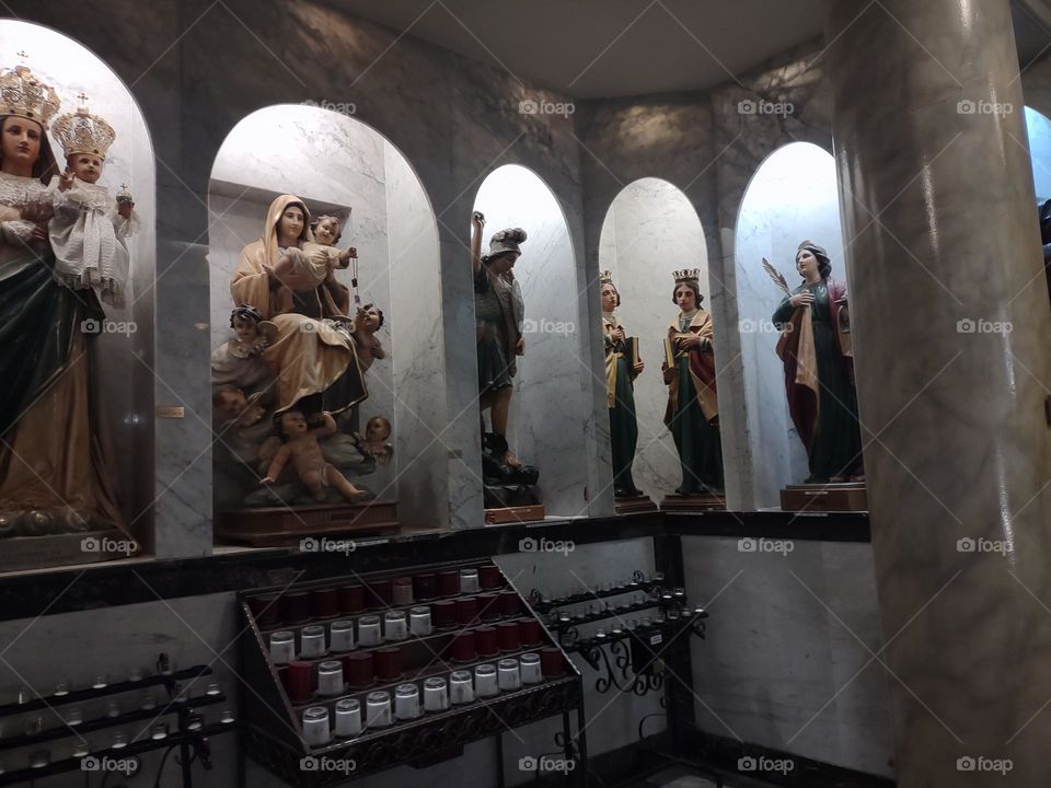 Niches for statues of several different saints, including a depiction of Our Lady with the scapular, built into the walls at the Shrine Church of the Precious Blood in Little Italy NYC