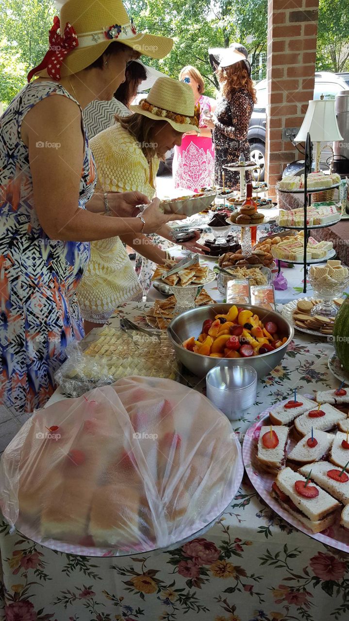 A delicious spread of food is set up for an afternoon tea party for the ladies.