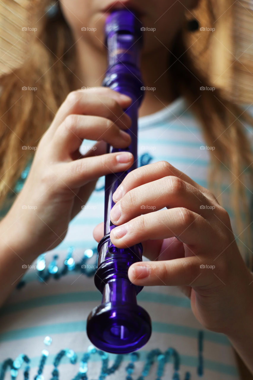 Little girl playing the recorder