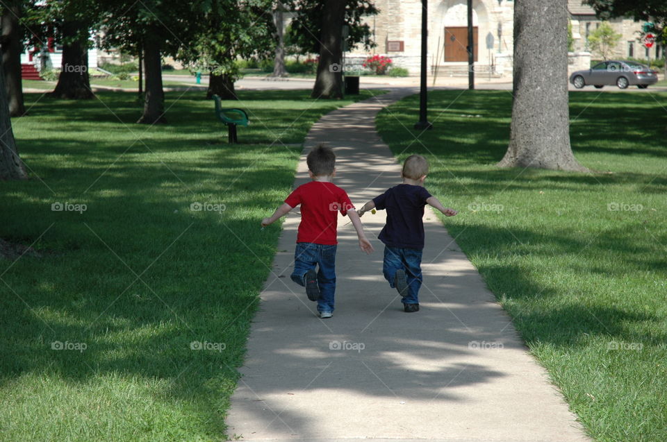 Running and Racing. Brothers running and racing through the park