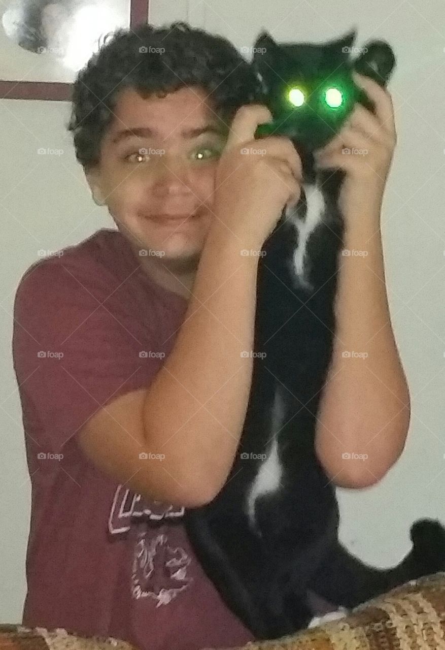 Laser eyes. My grandson and his cat. they both have light colored eyes so the reflection looks like this.