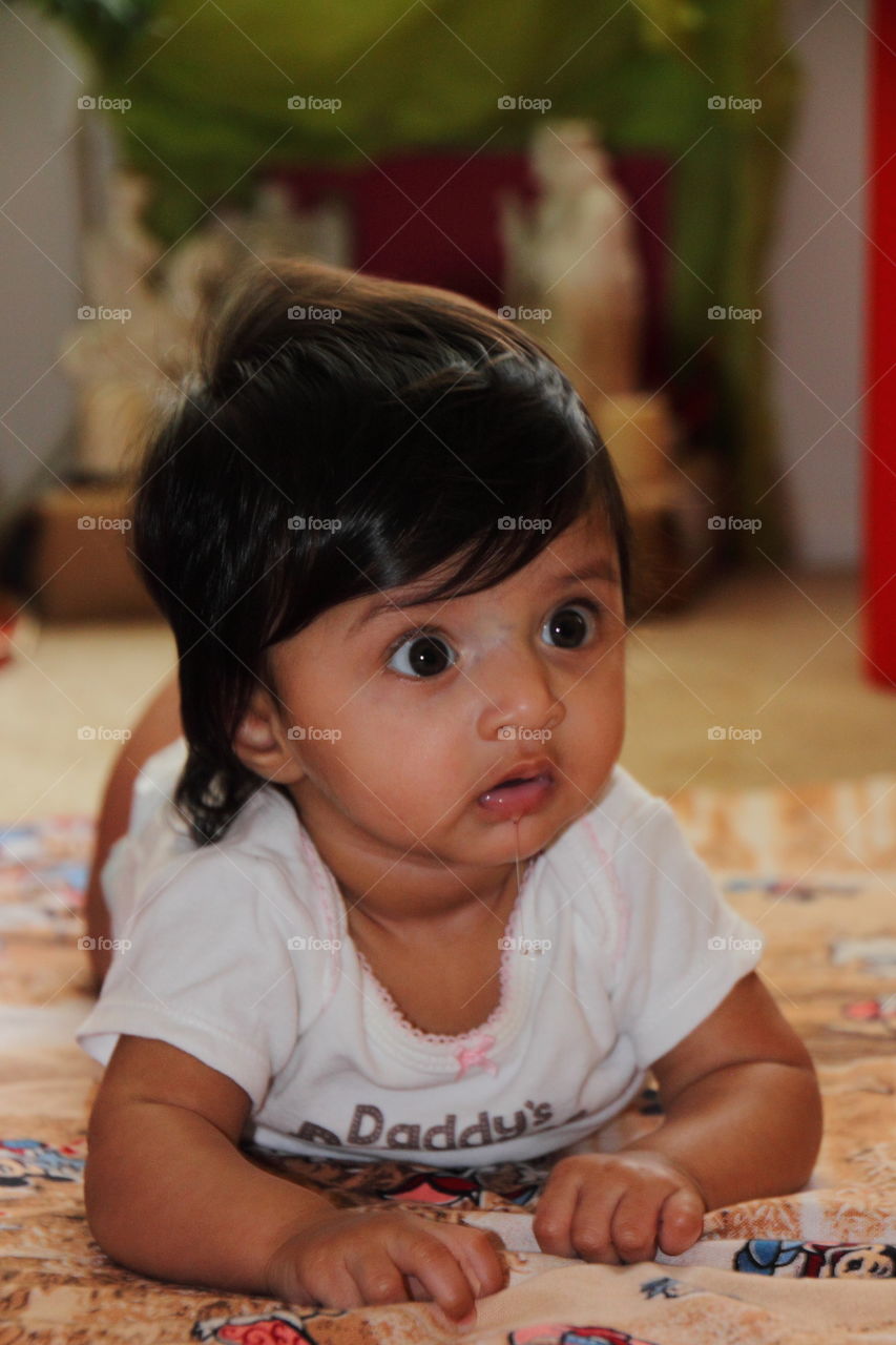 Baby lying down on bed