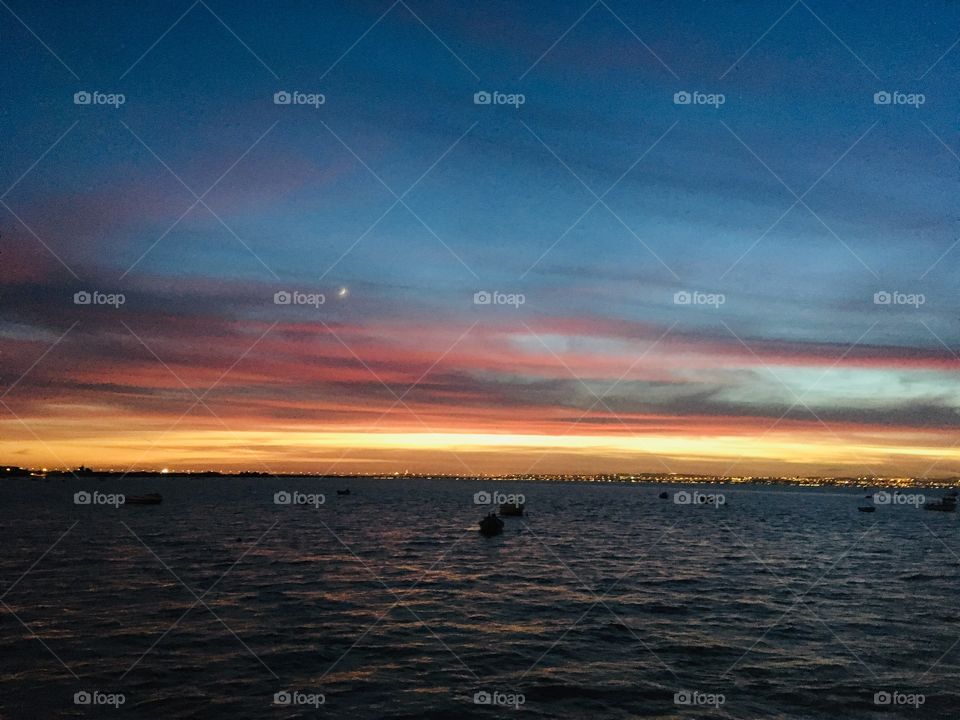 Ocean lighted by the sunset and the moon. Natural 