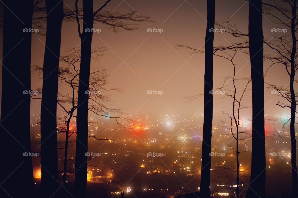 This shot reminds me of an old movie - close encounters. The lights from the city looks cool in the fog.