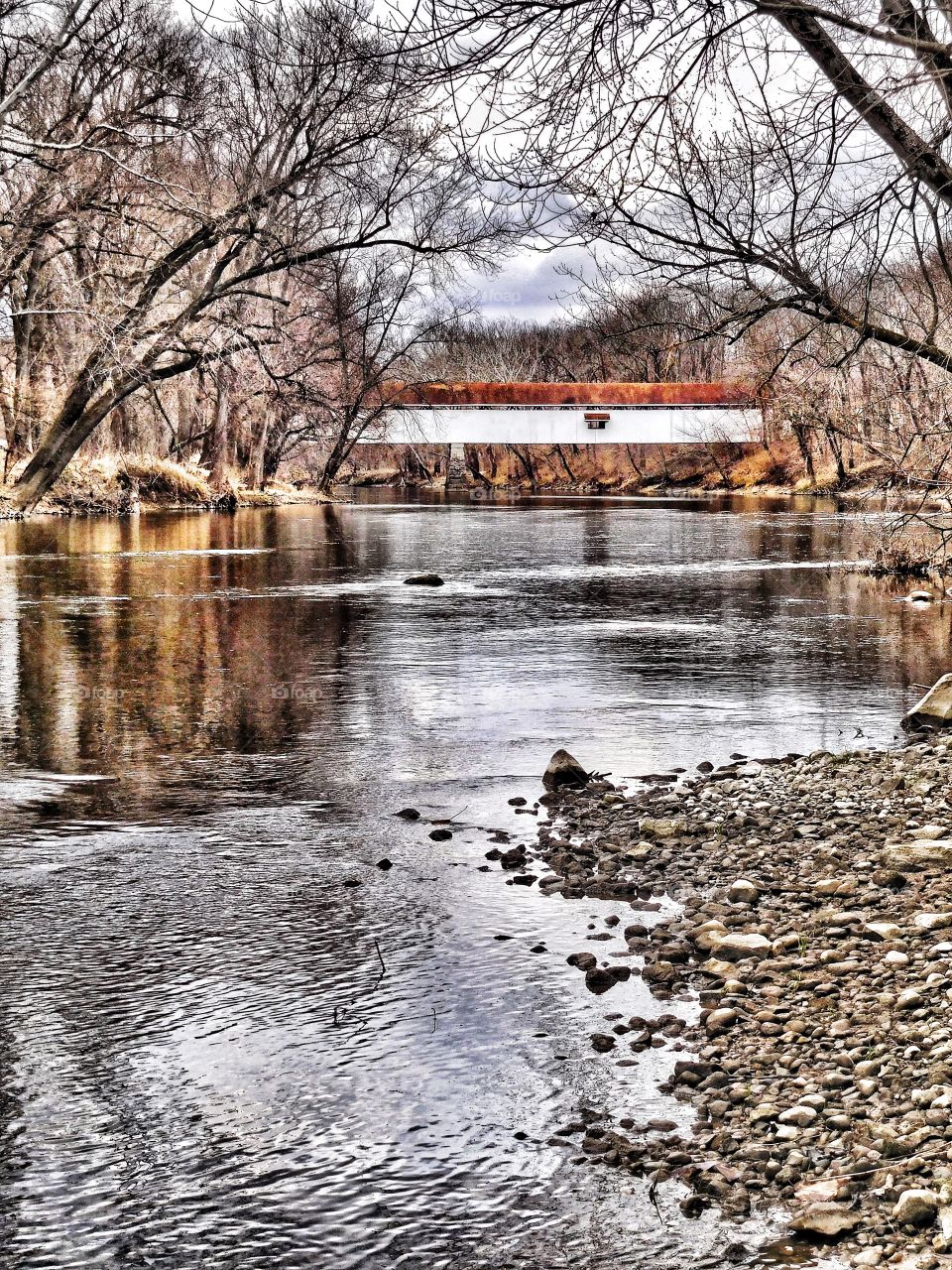 Covered bridge on the river. 