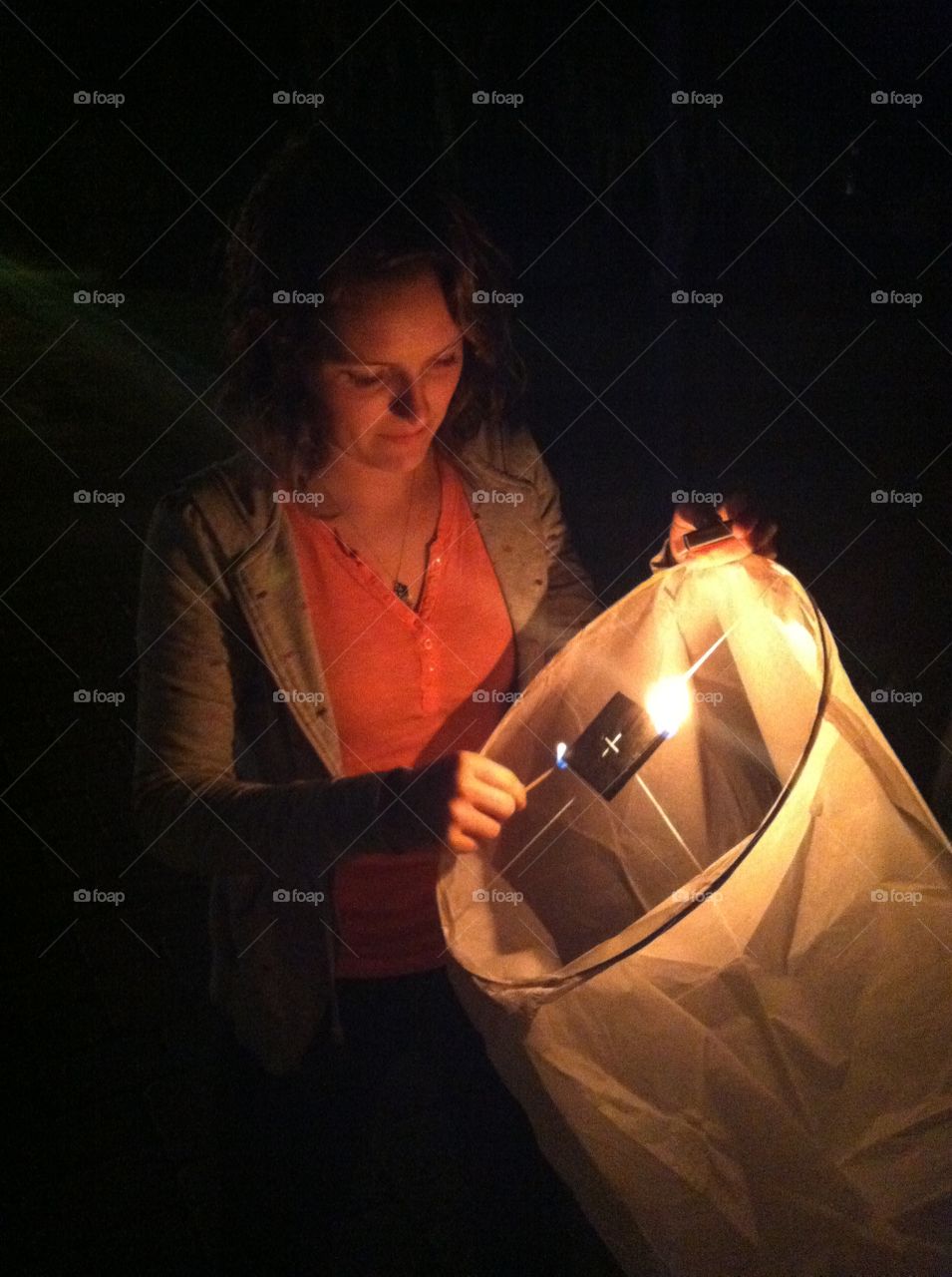 Lighting a paper latern for New Years