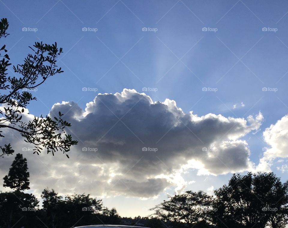 Sun rays . Sunset behind the clouds 