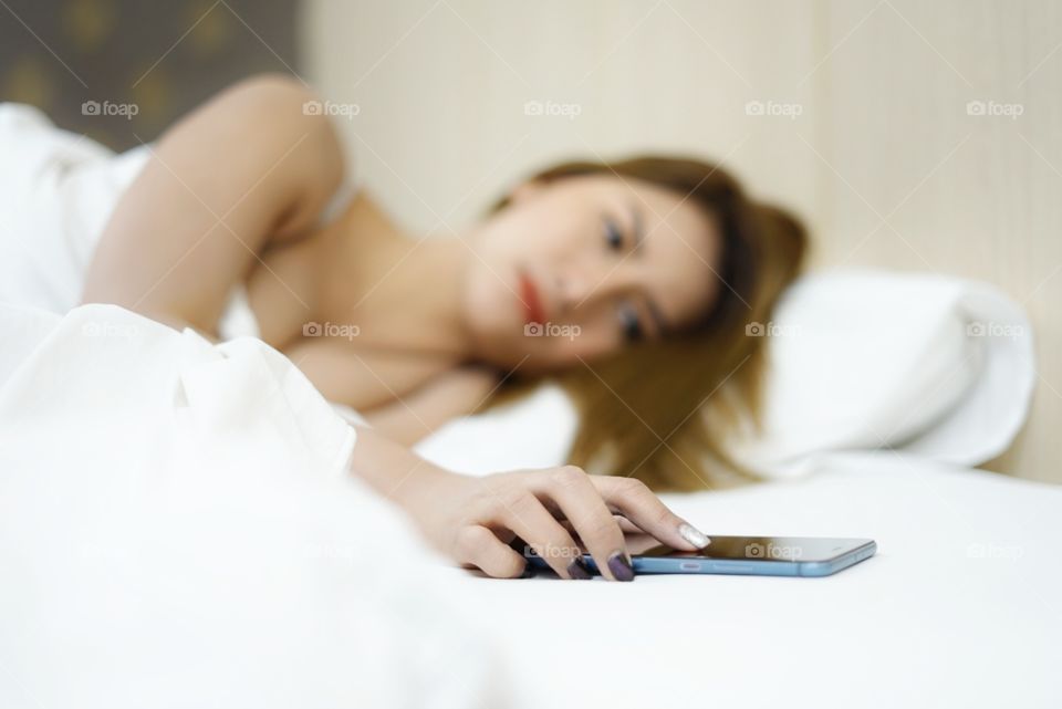 Woman turn off morning alarm phone