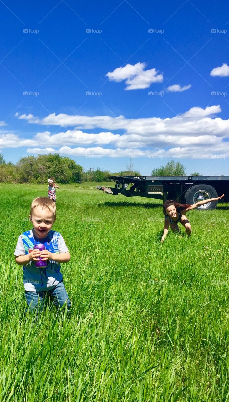 Kids playing on grassy landscape