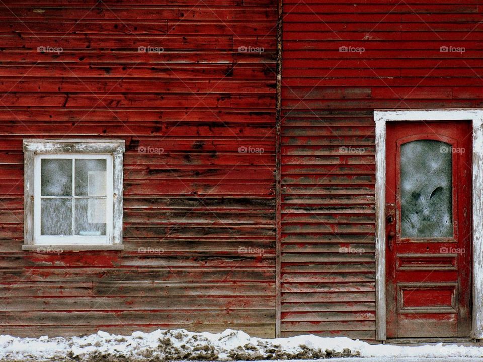 Passageways. A simple door and window surrounded by red clapboard