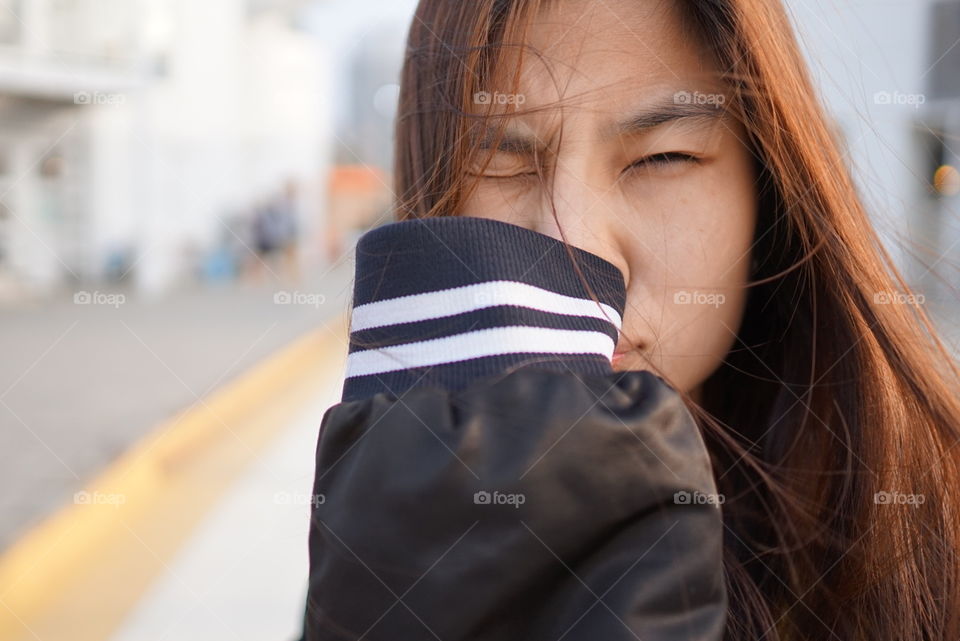 Cute Japanese girl cover her mouth in winter