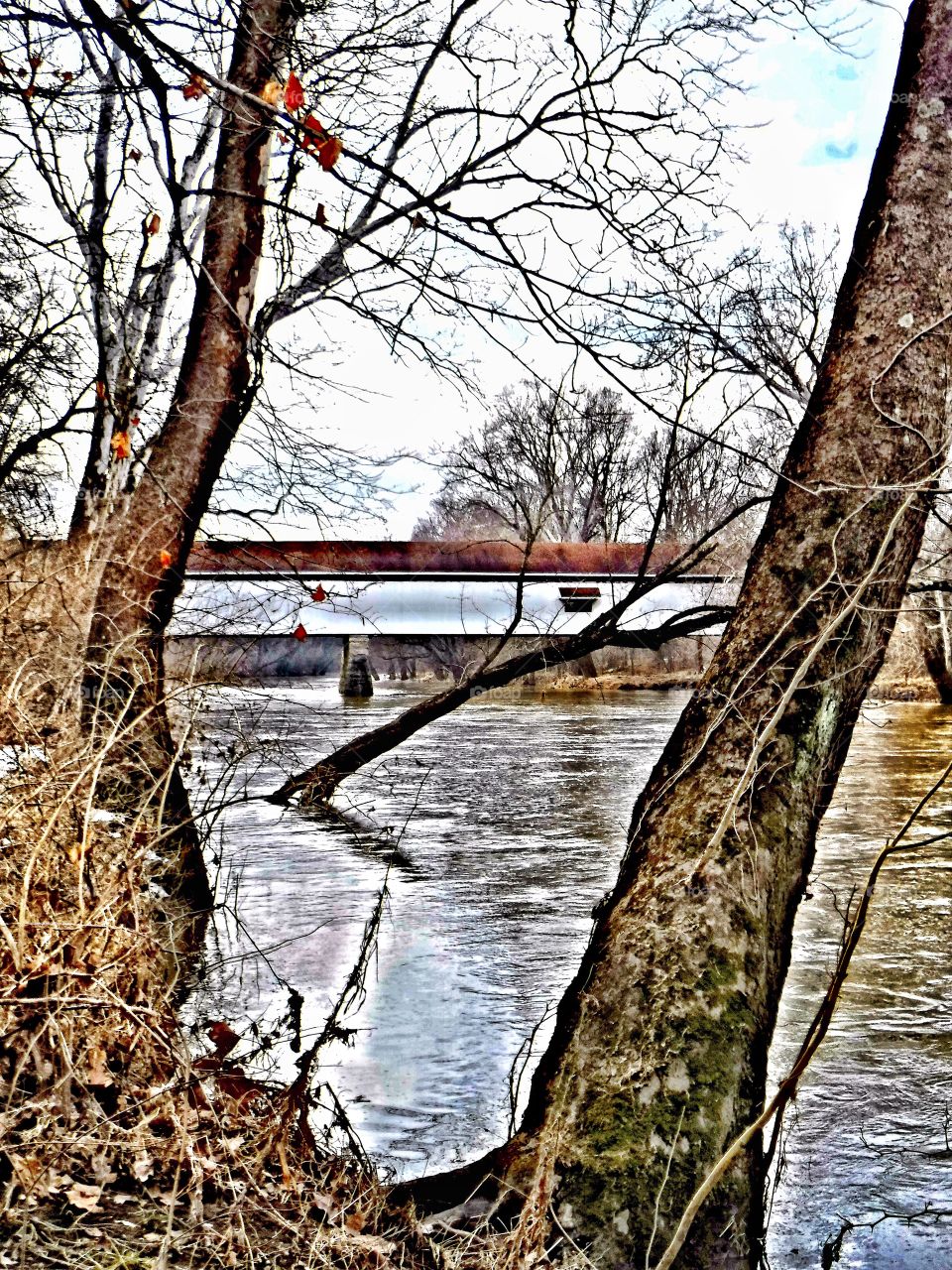 Covered bridge in Indiana on the river on a winter day 