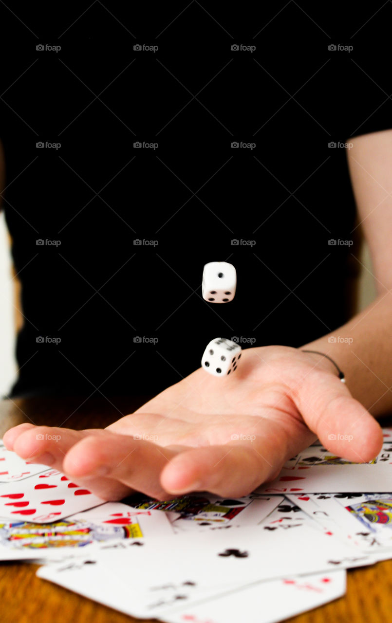 Flying dice in hand.