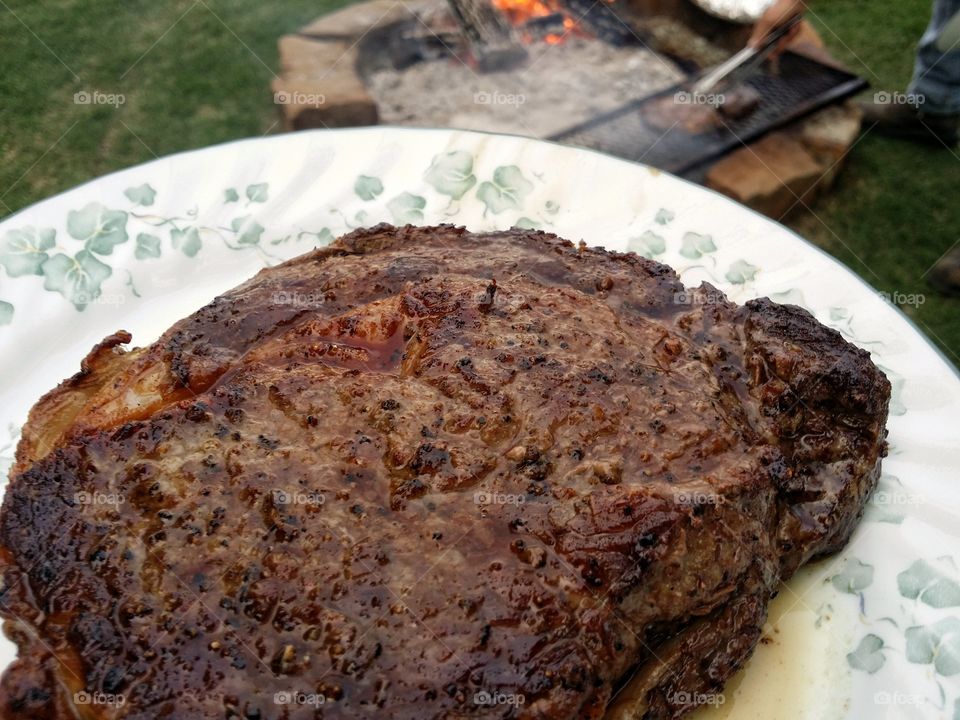 Ribeye Steak Cooked Over and Outside Open Flame Pit Closeup