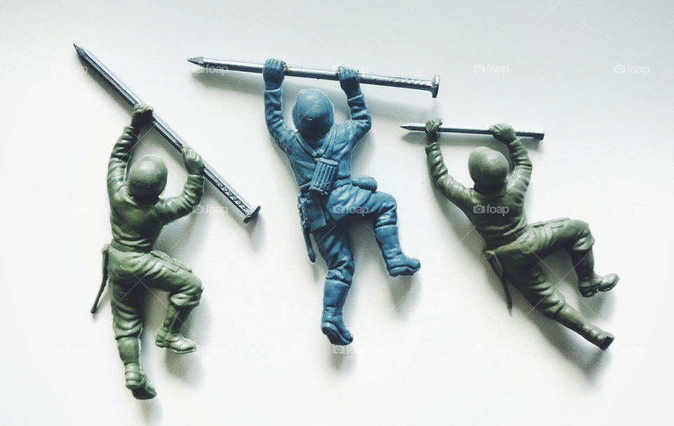 Toy soldiers with nails