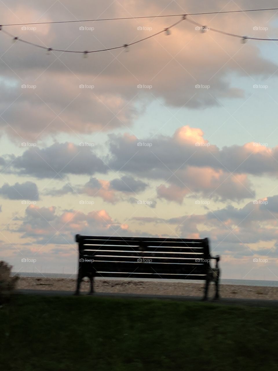 bench on the beach watching the clouds
