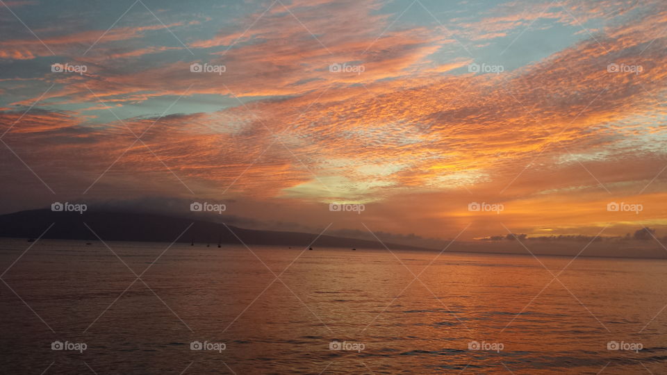 View of cloudy sky over sea at sunset