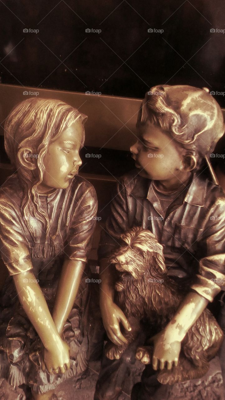 Vintage sculpture 
Girl and boy with his little dog sitting on bench and talking friendly