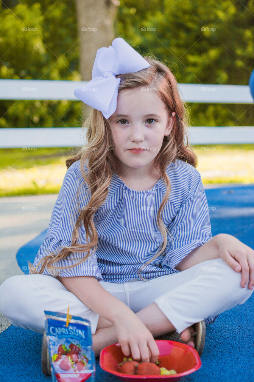 Young Girl Eating Fruit at the Park 3