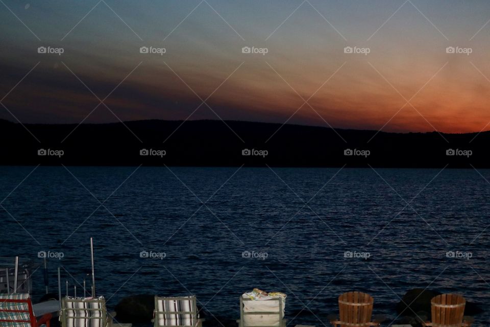 Sunset over the mountains in the Adirondacks lake region, lakeside 