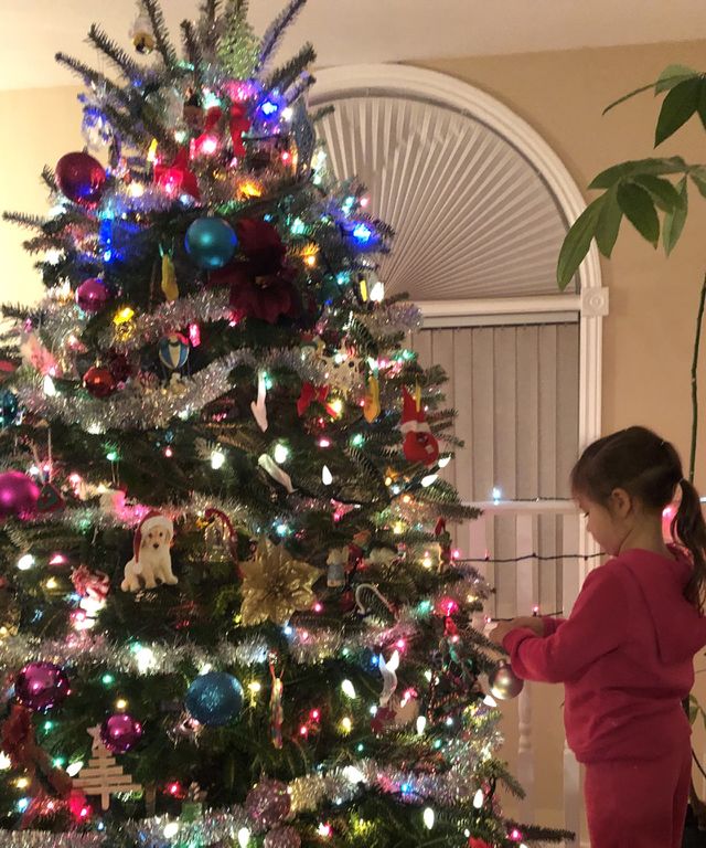 Little Girl Decorating her Christmas Tree