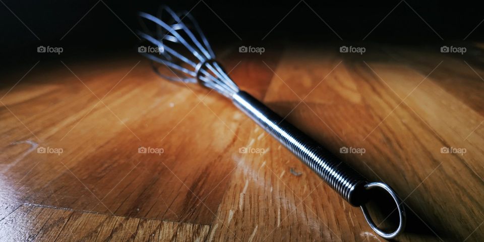 The whipping cream is a cooking tool that is used to whip cream or beat eggs. In this photo is taken up with a change of focus that enhances the contrast of the picture.