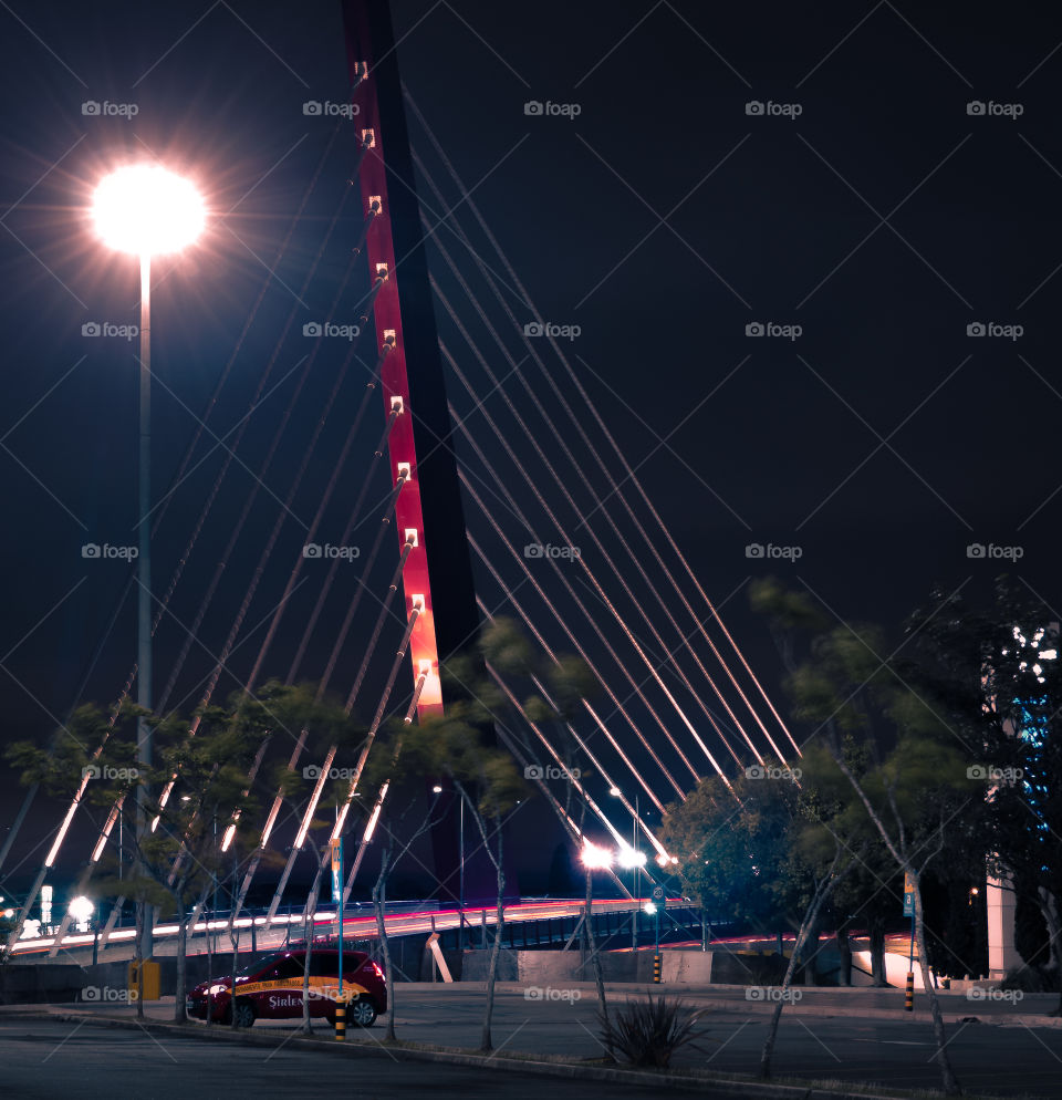 Cars passing by the cable-stayed bridge