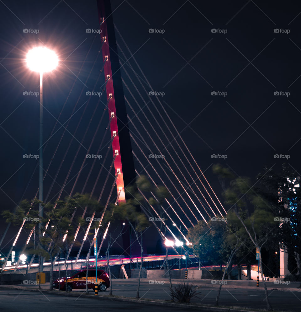 Cars passing by the cable-stayed bridge