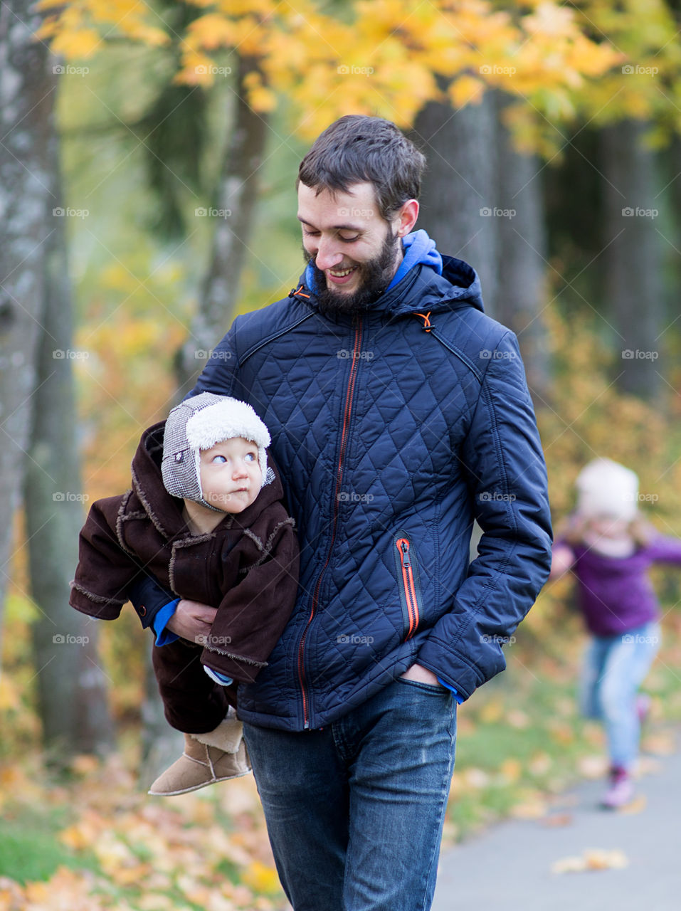 Dad and baby boy walking in autumn park