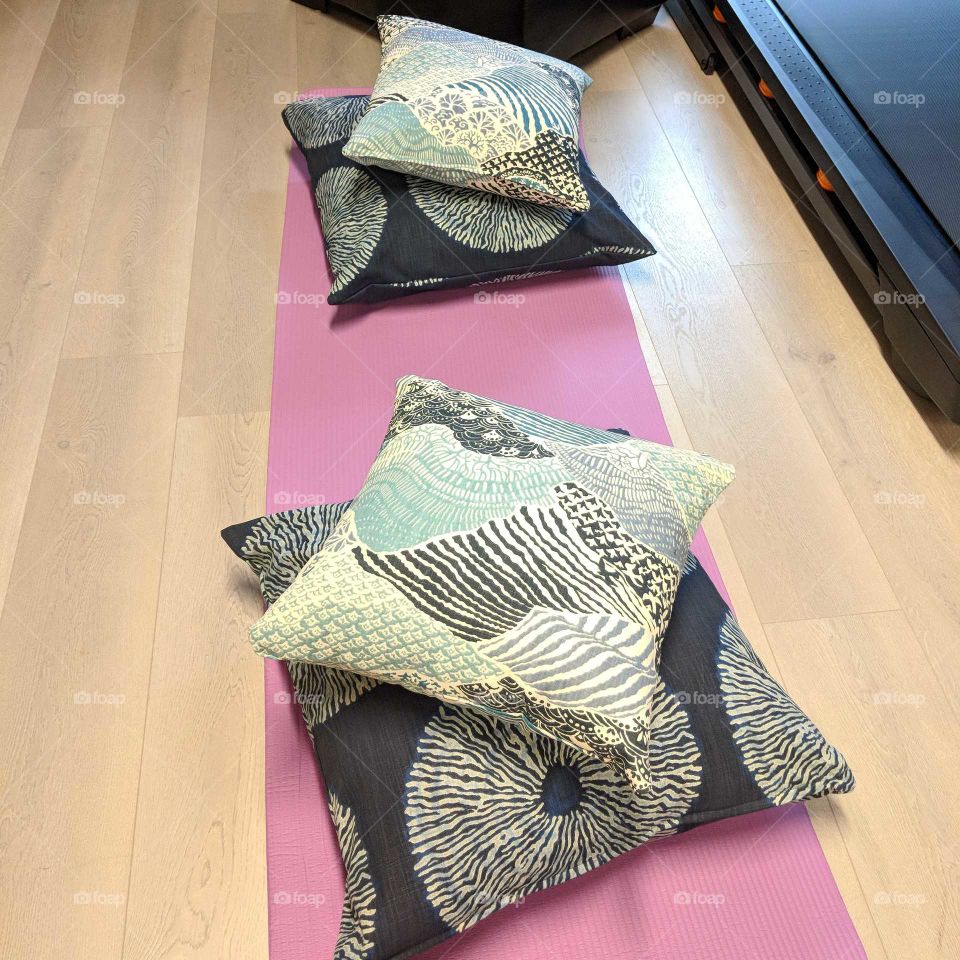 Meditation pillows. Simple yoga meditation set up for two. navy blue and purple. Small exercise space. Apartment exercise area.
