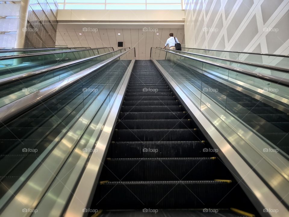 Business man on an escalator 