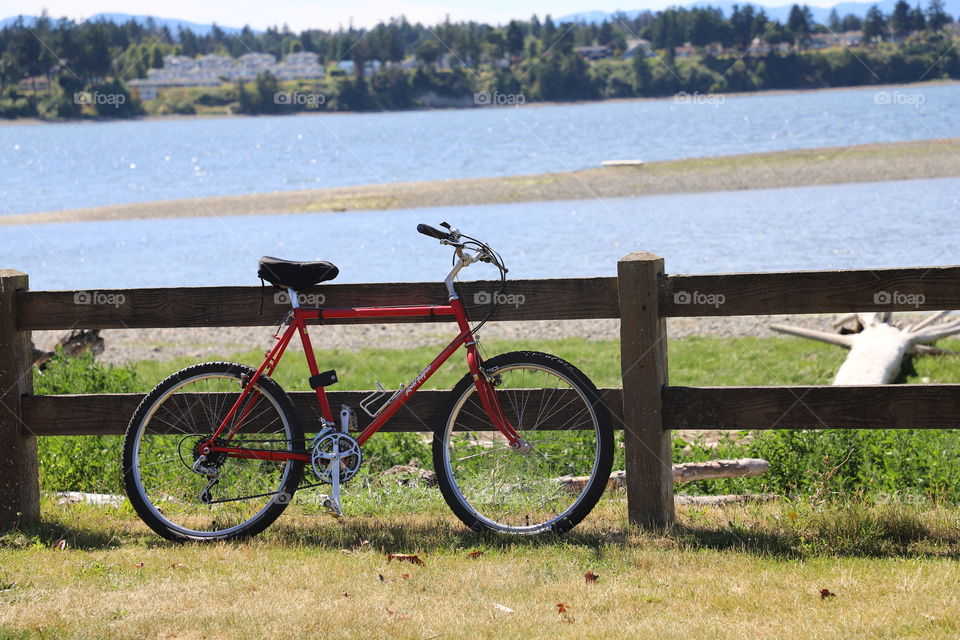 Bike by the fence on the shore