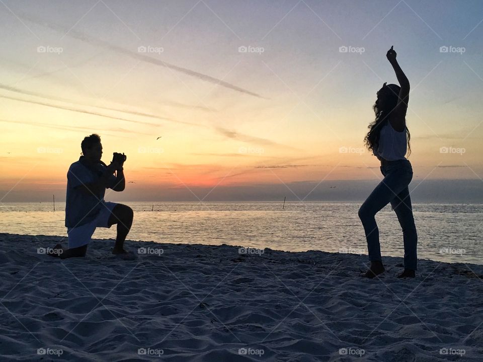 Photographer with model at sunrise 