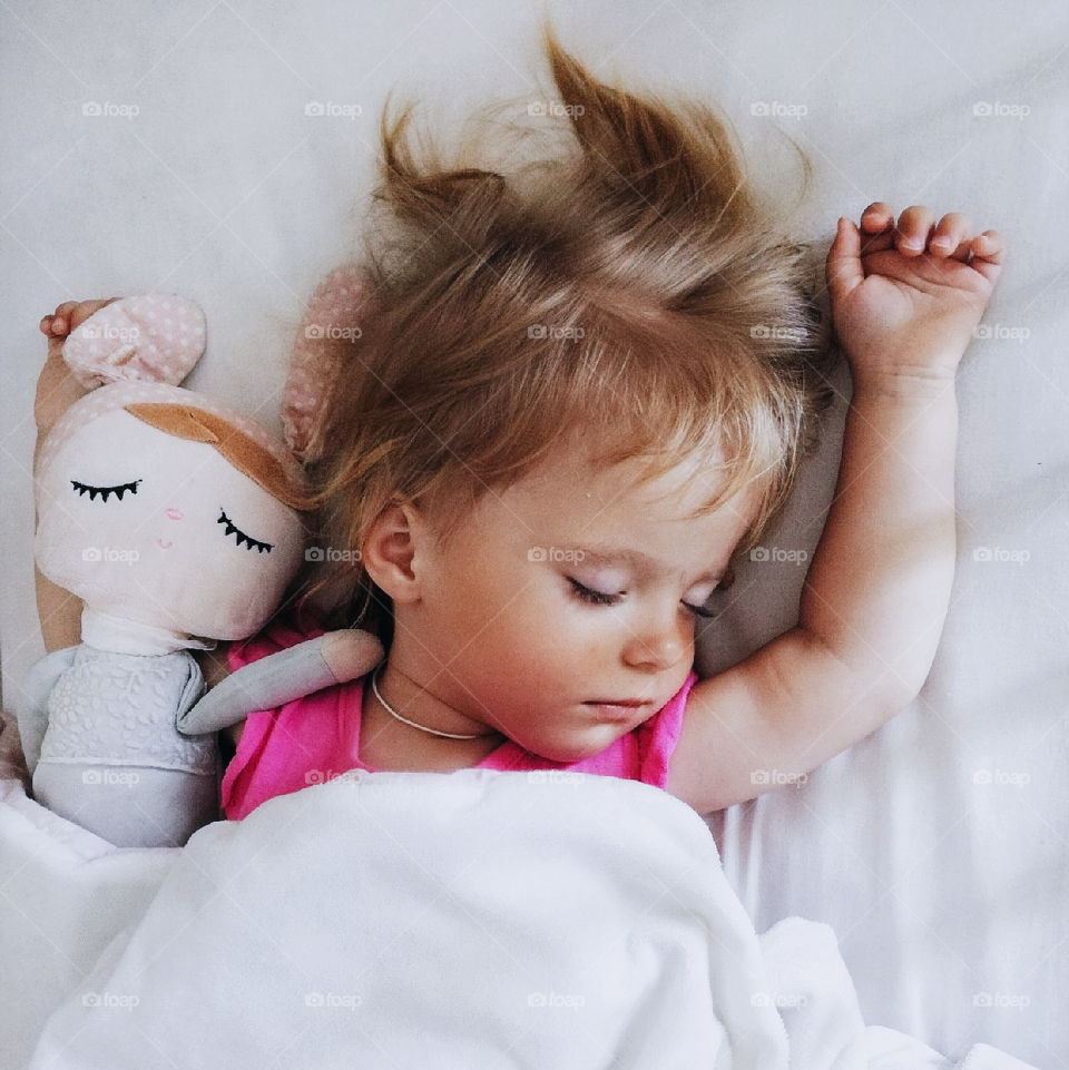 girl sleeping in her crib