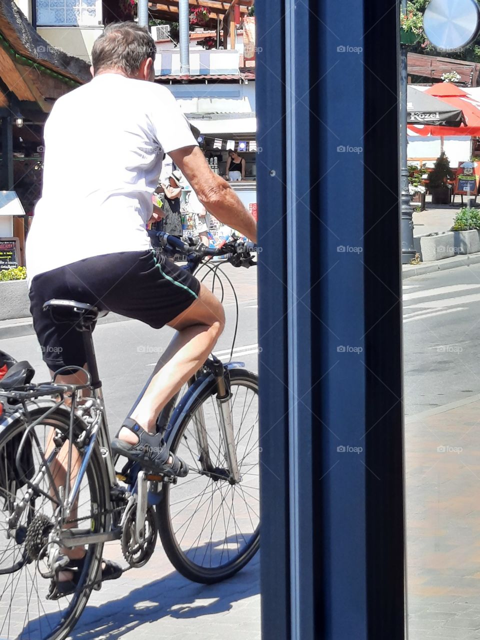 man on a bike in the centre of seashore  village