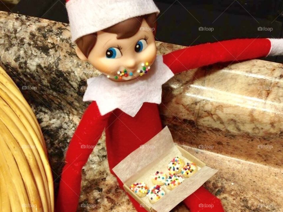 Elf on the shelf eating donuts 