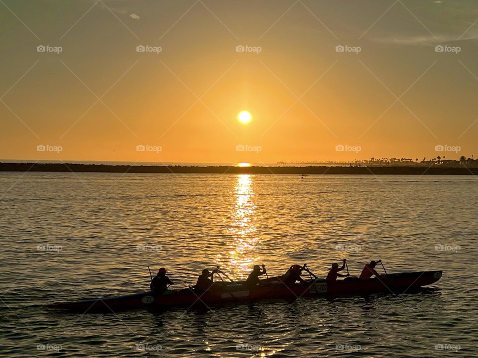 Beautiful sunset on Corona del Mar State Beach with a canoe in front of it
