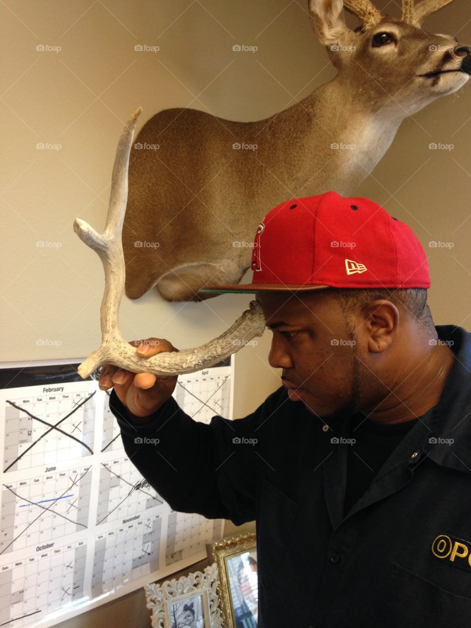Man touching antler his forehead