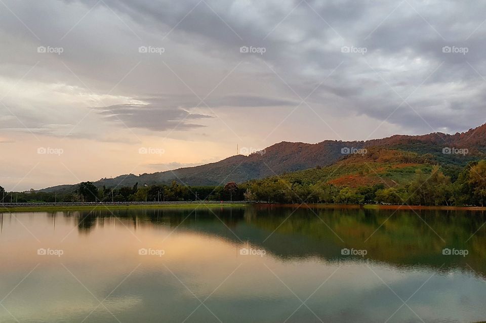 Scenic view of lake against sunset sky