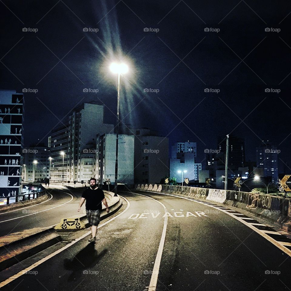 A man walks towards São Paulo city downtown. 