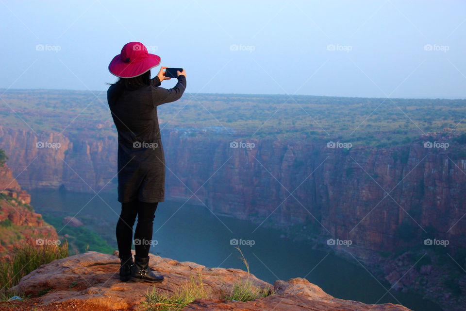 Lady taking selfee on mountain edge, adventures girl