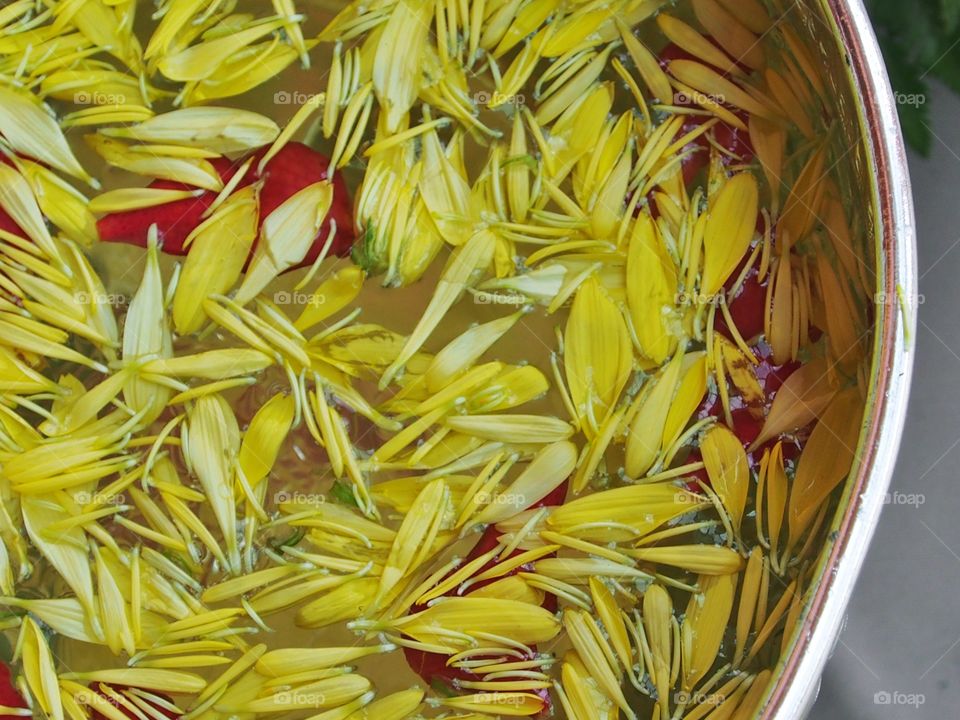 Water in bowl mixed  with flowers corolla for Songkran festival in Thailand