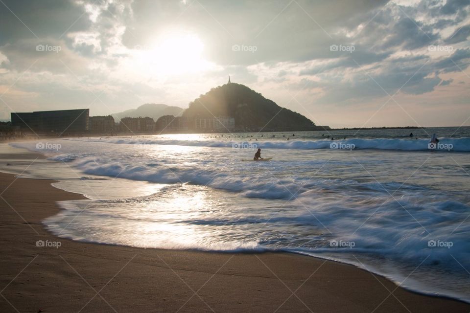 People at a beach in spain at sunset