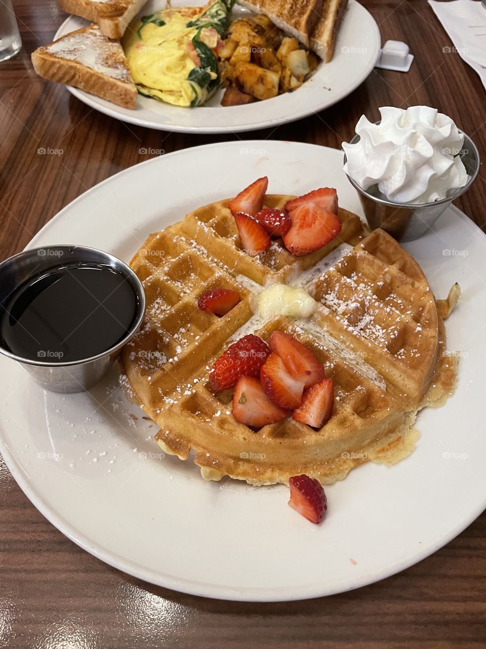 Waffles with strawberries and whipped cream