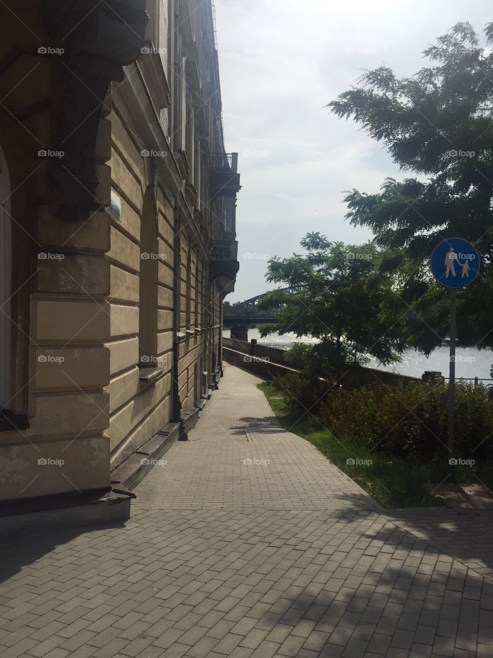A walkway on the river bench by the building