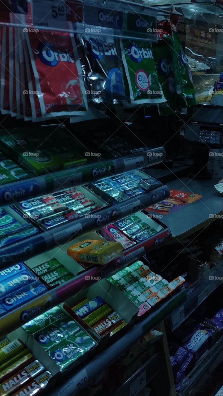 the cold light in the store saturates this room with some kind of horror movie effect. something mysterious, as if something is about to happen-a bandit will attack, demanding money from the cash register and holding a cold barrel of a pistol .