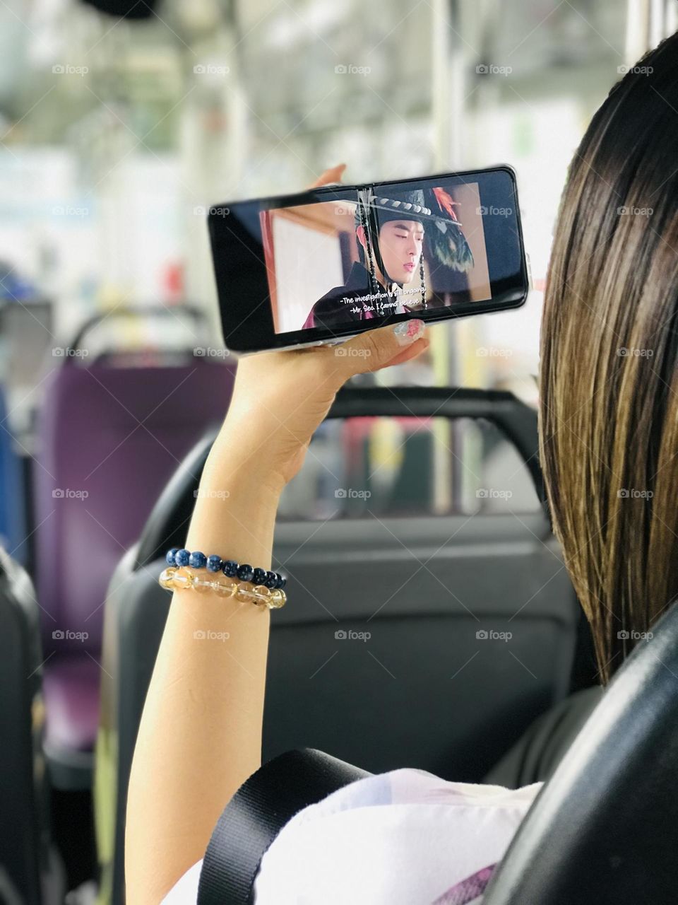 Watching movie on phone while going in bus 