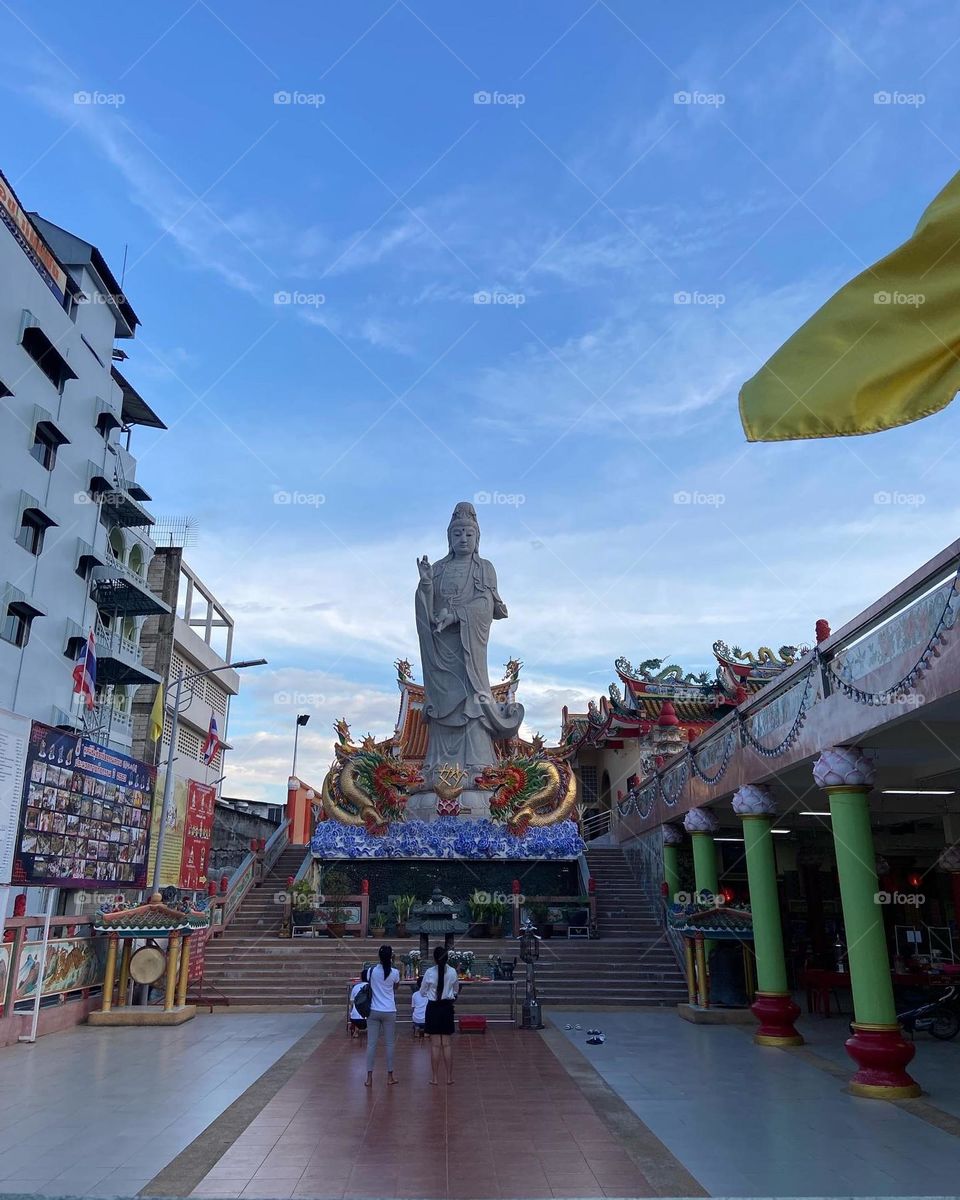 Large stone Buddha with blue sky backdrop 