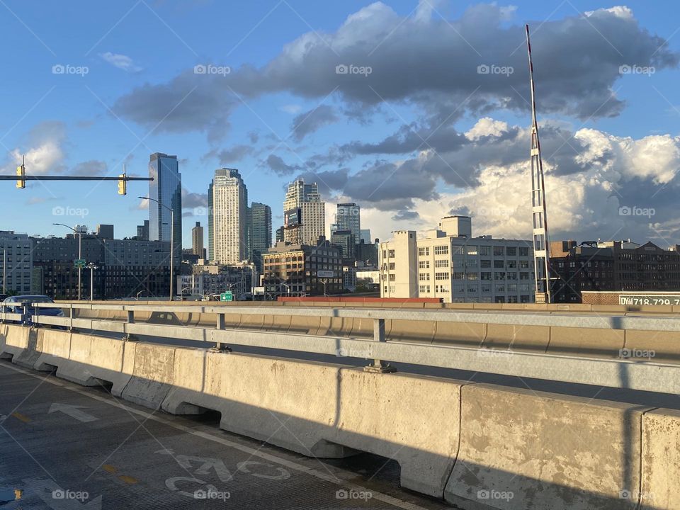 “Long Island City”, Queens as seen from the “Pulaski Bridge” makes a stunning dramatic motif in the light of the setting sun during the golden hour at dusk. 2023. Hypnotic Productions